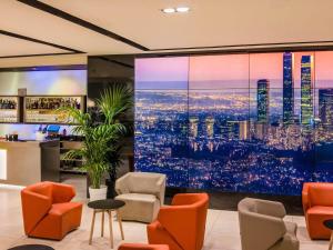 a lobby with a large projection of a city at Novotel Madrid Center in Madrid