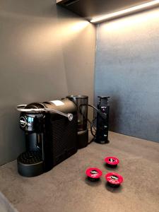 a coffee maker sitting on a counter with two red plates at Perućac Lake Residence in Miličevići