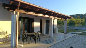 a patio with a table and chairs on it at Oasi 29 in Morlupo