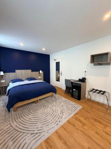 a bedroom with a large bed and a desk and a desk at Laulique in Les Lilas