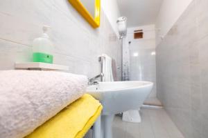 a white bathroom with a sink and a mirror at Agriturismo Millepini in Peschici +50 photos