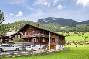 a house with two cars parked in front of it at Haus Helena Sophia in Au