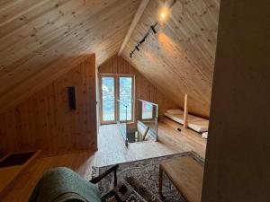 an attic room of a wooden cabin with a large window at Malnestomten in Henningsvær +7 photos
