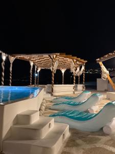 a stage with blue and white slides at night at Silia Dream View in Houlakia