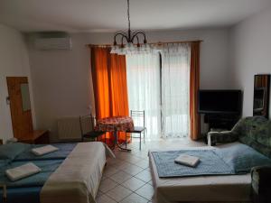 a living room with a bed and a couch at Abigel Thermal Apartman in Bük