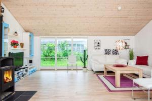 a living room with a white couch and a table at Coastal Hideout Vacation Home in Bøtø By +18 photos