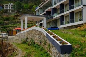 a retaining wall with flowers in it in front of a building at Luxe Vista Resort Kodai in Kodaikānāl