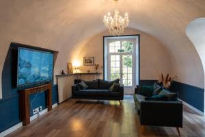 a living room with a couch and a tv at Chateau de Mons Gard prés d Uzes in Mons