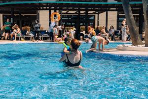 a group of people playing in a swimming pool at Smy Isla Cristina in Isla Cristina
