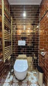 a bathroom with a white toilet in a brick wall at De Gouden Cruytbusse in Middelburg +33 photos