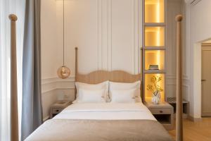 a bedroom with a large bed with white pillows at Heritage Hotel Zagreb Dubrovnik in Dubrovnik