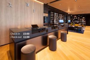 a wine tasting room with a counter with laptops on it at Hotel Intergate Osaka Umeda in Osaka