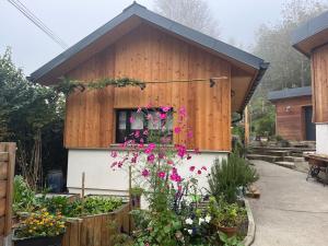 a house with a bunch of flowers in front of it at La Cabane - Studio à la campagne avec Clim - Annecy 15 min in Marcellaz-Albanais