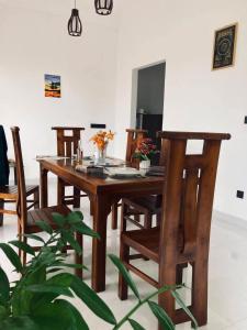a wooden table and chairs in a living room at Villa SOORYAALI in Galle