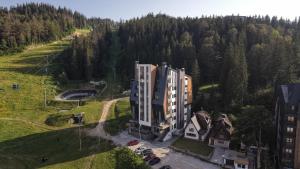 an aerial view of a building in the middle of a forest at Aparthotel Poljice in Jahorina