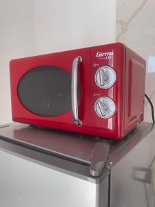a red microwave sitting on top of a shelf at Casa Vacanze Nautilus in Termoli +14 photos