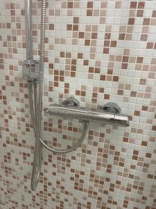 a shower in a tiled bathroom with a hose at Casa Vacanze Nautilus in Termoli