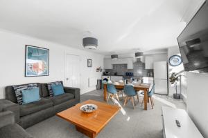 a living room with a couch and a table at Henry's Apartment on Commercial Street in Dundee