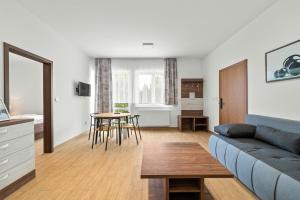 a living room with a couch and a table at Apartmány Star Lipno - Self Check-in in Lipno nad Vltavou