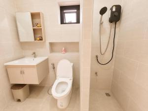 a bathroom with a toilet and a sink and a shower at Kulanat House in Chiang Mai