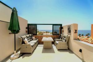 a living room with a couch and chairs and a table at Paz Ocean View Luxury, 2 Air conditioners, Fast Wifi, Heated pool in San Miguel de Abona