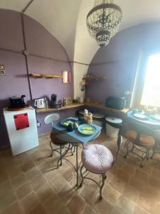 a kitchen with a table and chairs and a refrigerator at NATURA rooms&sport in Finale Ligure