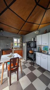 a kitchen with a table and a checkered floor at La Rond'Dada in Sainte-Suzanne