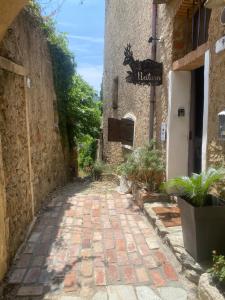 an alleyway in an old stone building with a street sign at NATURA rooms&sport in Finale Ligure