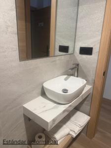 a bathroom with a white sink and a mirror at Avenida Gijón Centro in Gijón