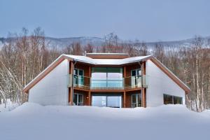 a house in the snow in the woods at Modern house secluded in nature in Storbukt