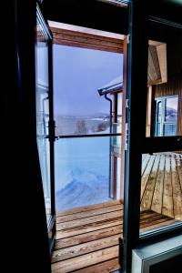 an open door with a view of the ocean from a house at Modern house secluded in nature in Storbukt