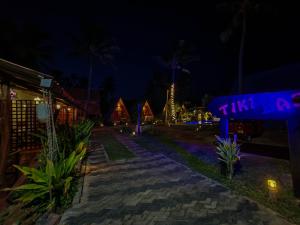 a lit up street at night with a group of houses at Nilaveli Sheen Coast in Trincomalee