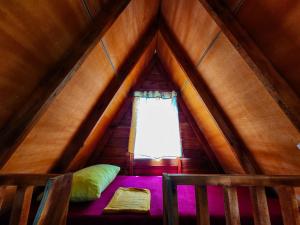 a bed in a room with a window in a pitched at Nilaveli Sheen Coast in Trincomalee +29 photos