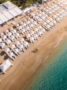 an aerial view of a beach with umbrellas and the water at Lichnos Beach in Parga