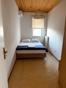 a bedroom with a bed in a room with a window at Sea View House B in Péra Mélana