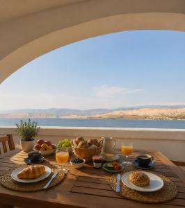 a breakfast table with a view of the ocean at Apartments Alma in Pag