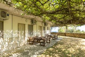 a group of benches sitting outside of a building at Agriturismo Millepini in Peschici