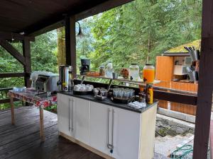 an outdoor kitchen with pots and pans on a deck at Penzión Astoria - bazén a oddych na Liptove in ľubochňa