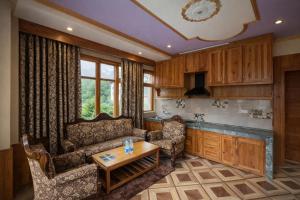 a living room with a couch and a table at Woods Villa Cottages Manali - 1,2,3,4 Bedrooms Luxury Cottages & Villa Available in Manali with Scenic Mountain View, Manali in Manāli +47 photos