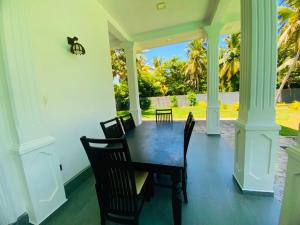 a dining room with a table and chairs at sunset villa in Hikkaduwa