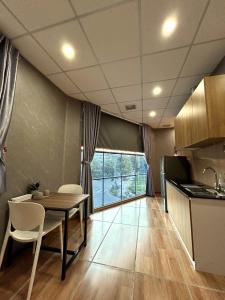 a kitchen and dining room with a table and chairs at Linh's House in Danang