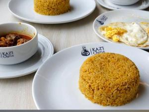 a table with plates of food and a cup of coffee at Kazi Castle Rajshahi in Rājshāhi
