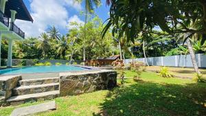 a swimming pool in the backyard of a house at sunset villa in Hikkaduwa