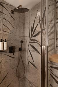 a bathroom with a shower with a plant mural on the wall at Heritage Hotel Zagreb Dubrovnik in Dubrovnik +63 photos