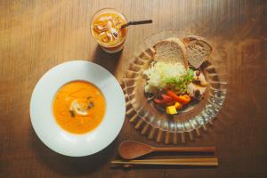 a table with a bowl of soup and a plate of food at Amu in Beppu +47 photos