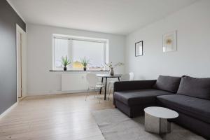 a living room with a couch and a table at Lovely cozy apartment in Søborg