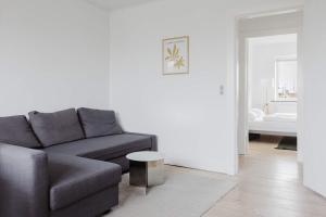 a living room with a couch and a table at Lovely cozy apartment in Søborg