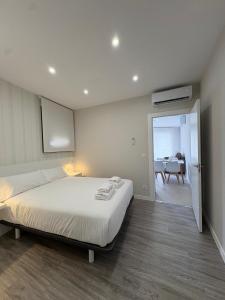 a bedroom with a bed and a dining room at O Lar de LUCI in Nigrán