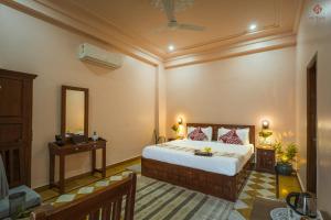 a bedroom with a large bed and a mirror at Eartham Stays, Pushkar in Pushkar +27 photos
