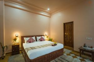 a bedroom with a large bed in a room at Eartham Stays, Pushkar in Pushkar